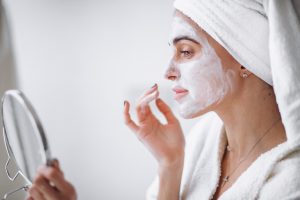 Woman aplying beauty mask,close up