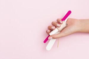 woman-holding-manicure-tools-with-copy-space